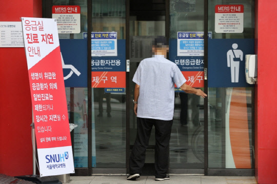 30일 오전 서울 종로구 서울대학교병원 응급의료센터 앞에 진료 지연 관련 안내문이 놓여 있다. <연합뉴스>